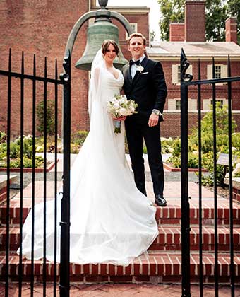 Bride and Groom behind the gate in front of the Liberty Bell